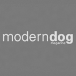'modern dog magazine logo on a gray background'